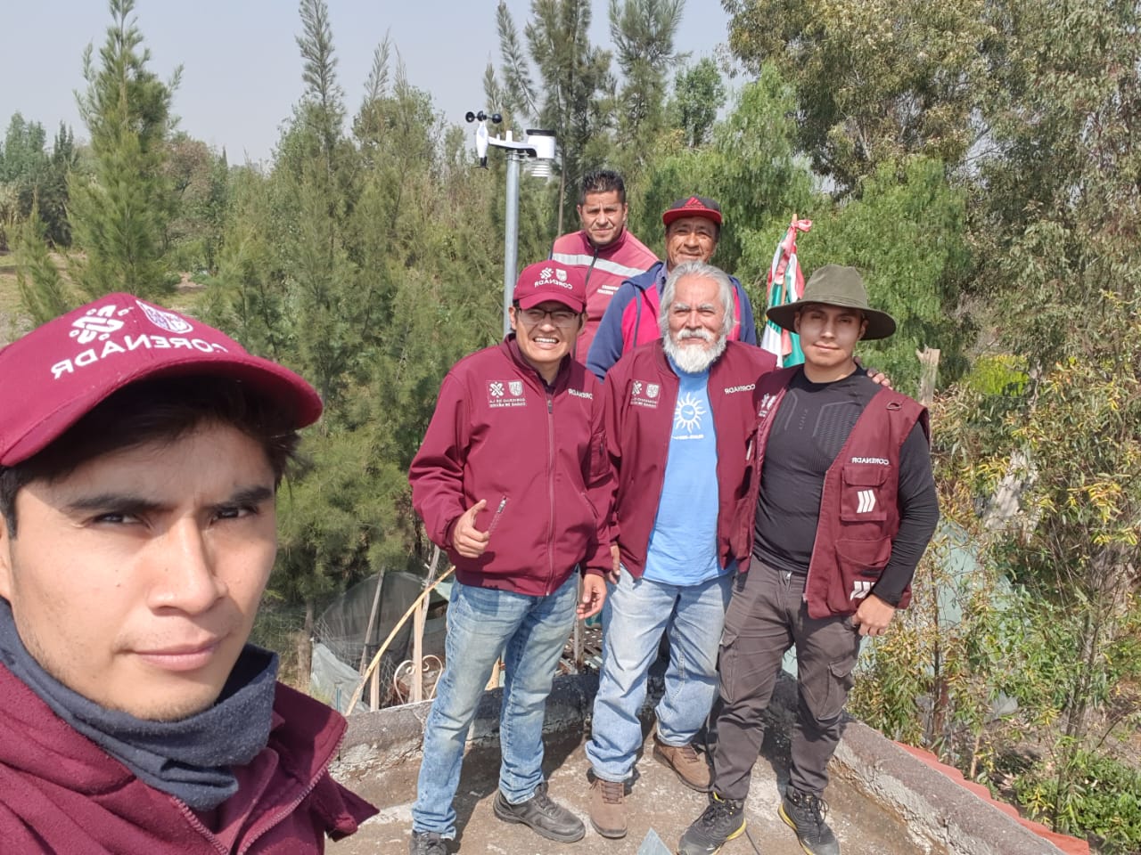Field deployment crew installing a WeatherXM weather station for forest microclimate monitoring